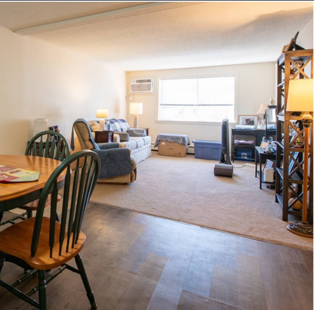 Renovated open living and dining area with luxury vinyl plank flooring