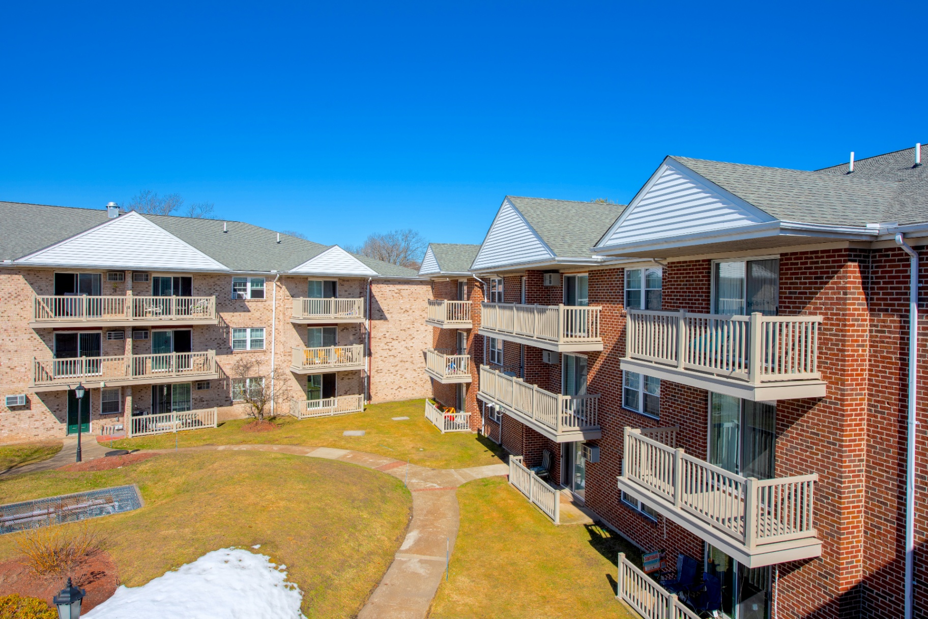 Interior courtyard view of Parlmont Park Apartments with brick facades and private balconies